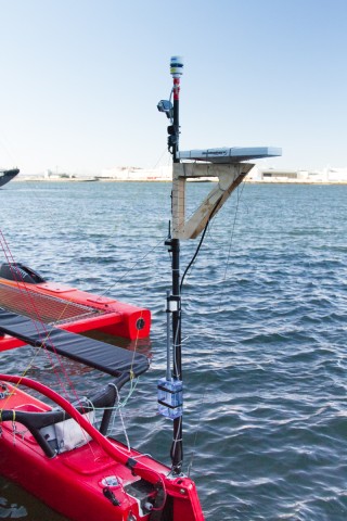 Stern pole with Airmar wind sensor at top, Hemisphere compass on wooden mount, and GoPro Hero3 between.